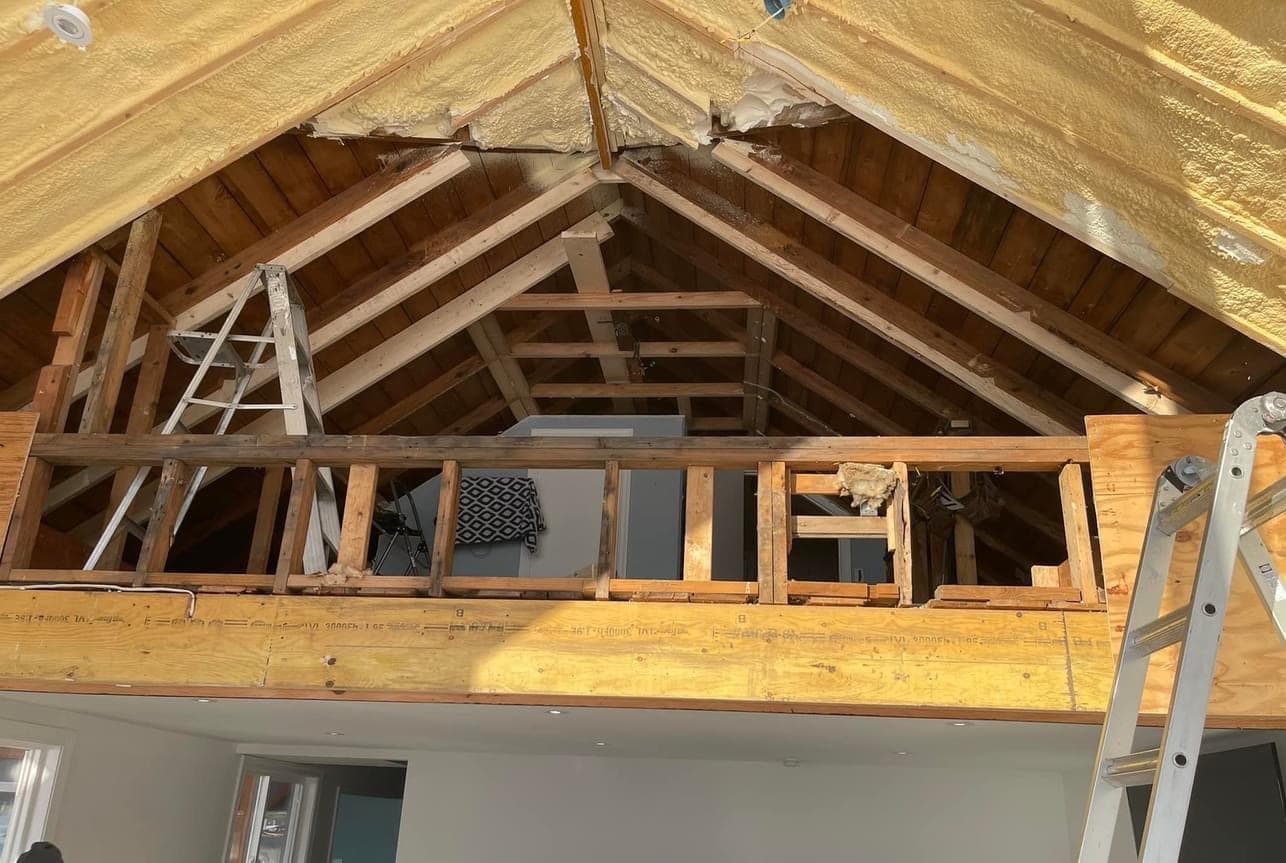 Attic loft addition showing exposed wood framing and spray foam insulation