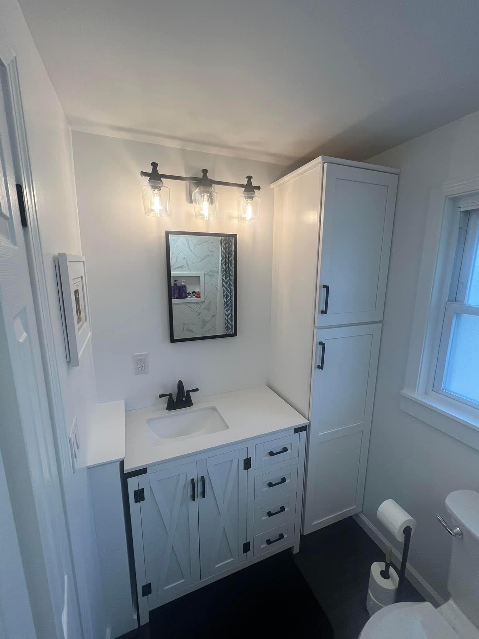 Modern white bathroom with farmhouse-style vanity and black fixtures