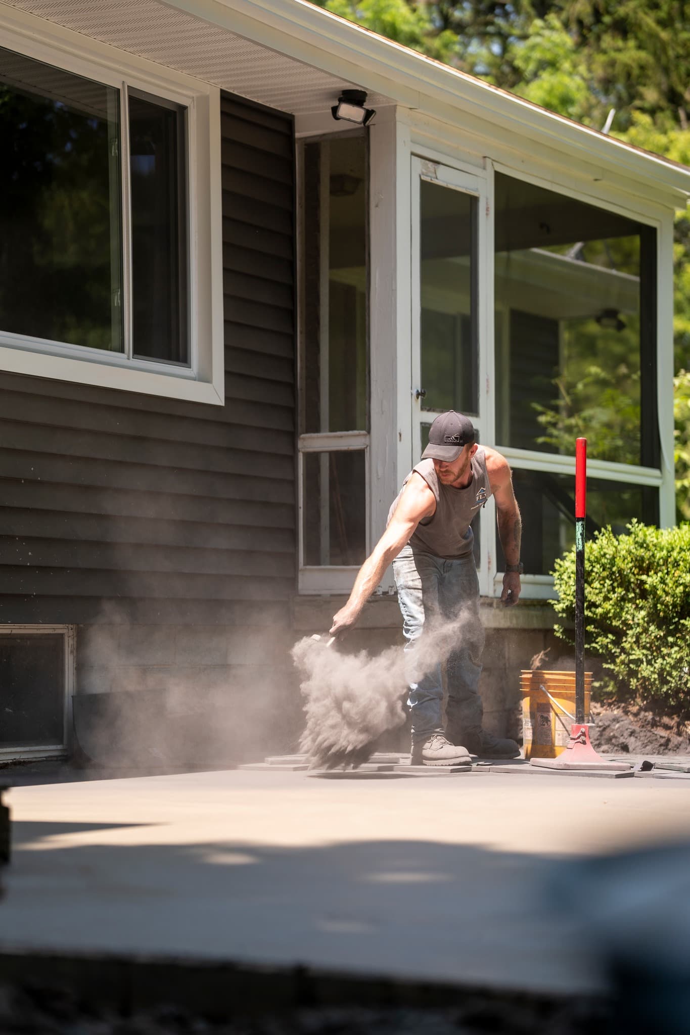 Worker using high-pressure water cleaner on concrete surface