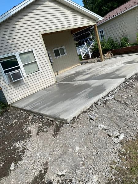 Newly poured concrete driveway leading to residential garage