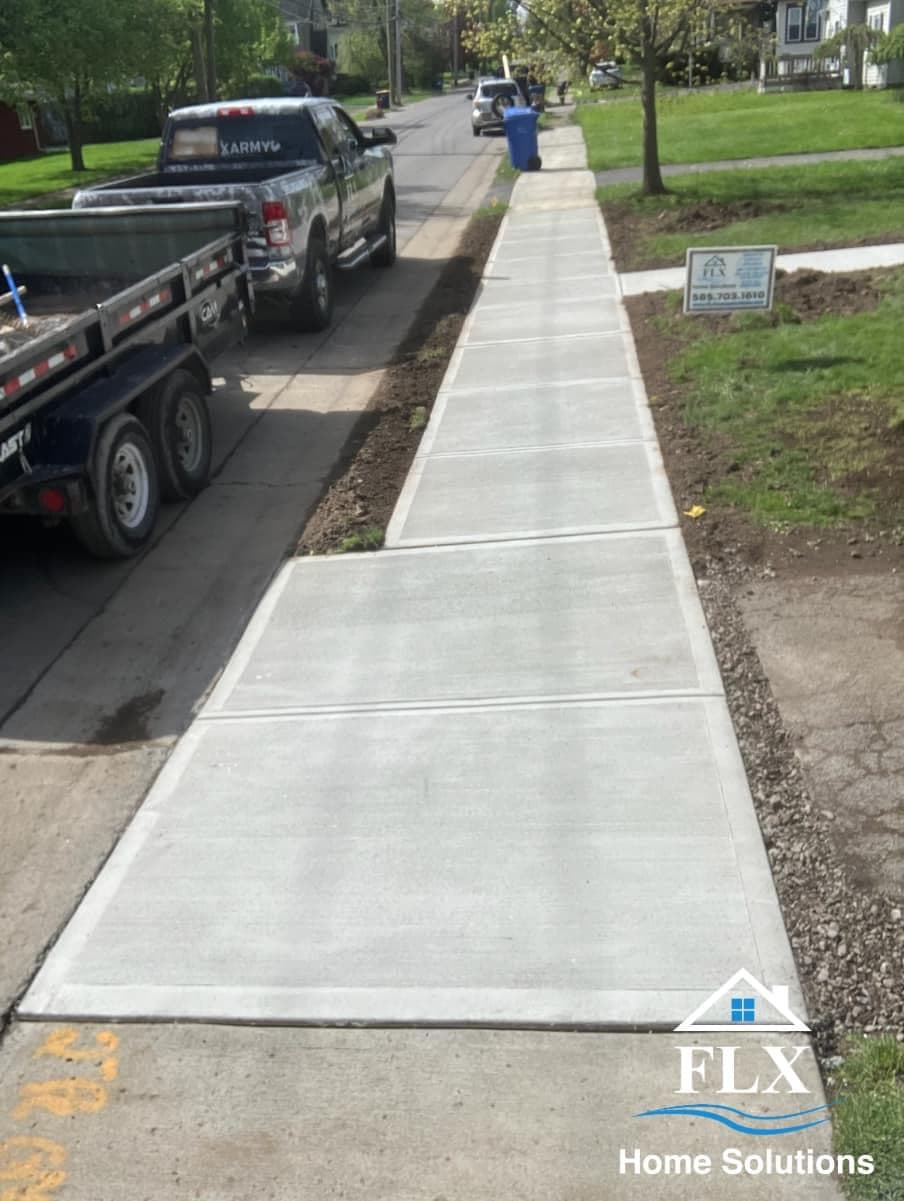 New concrete sidewalk with expansion joints along residential street