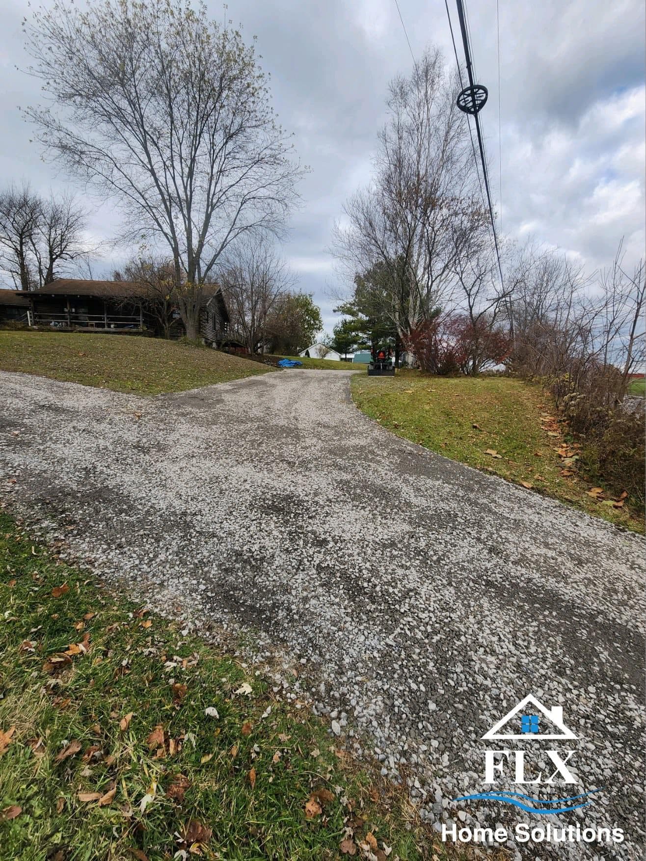 Gravel driveway leading to cabin before concrete paving installation