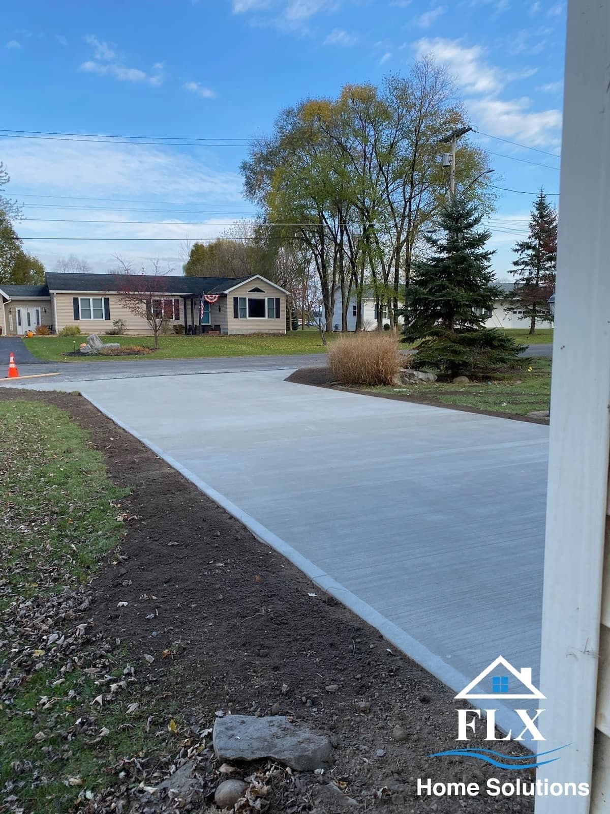 Newly poured concrete driveway leading to residential home
