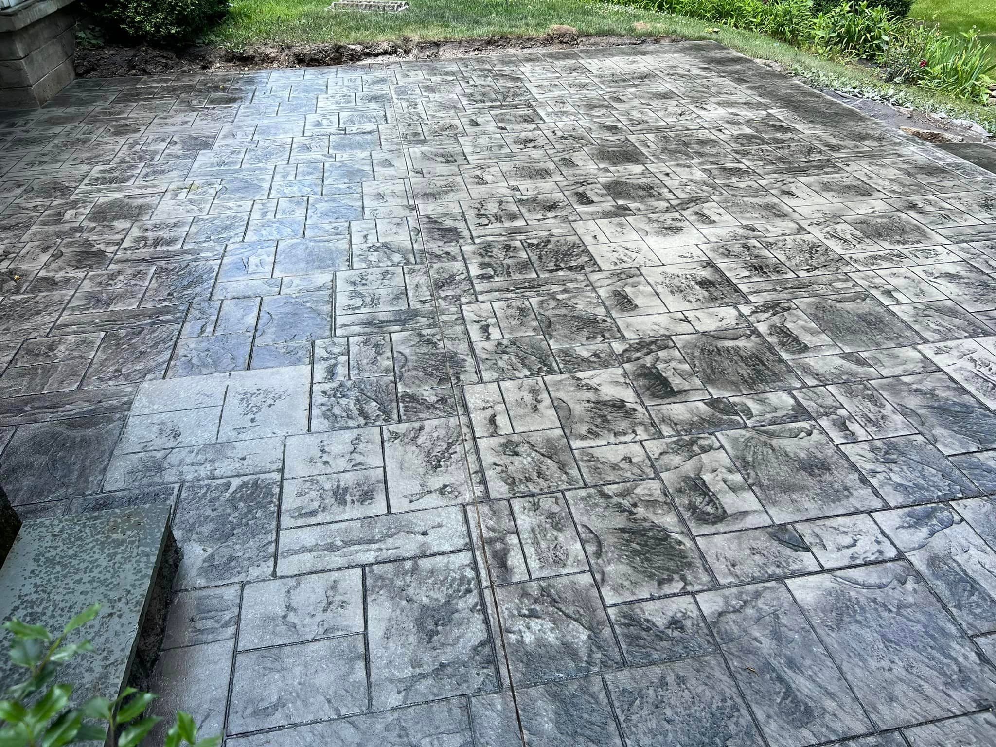 Stamped concrete patio with ashlar slate pattern in gray tones