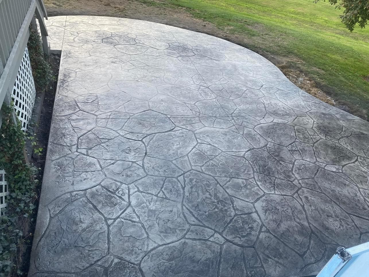 Gray stamped concrete patio with irregular stone pattern