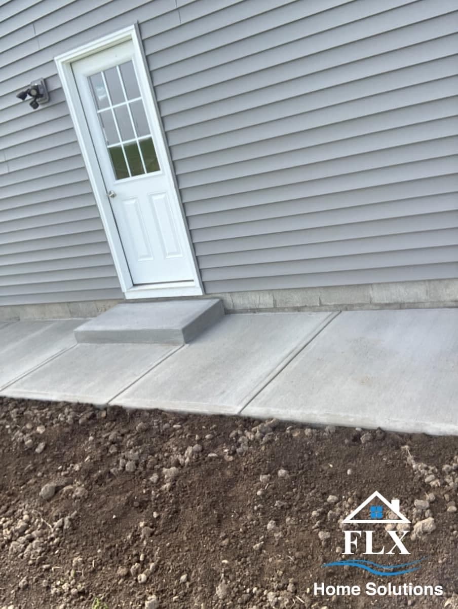 White door improperly installed at an angle on concrete stoop