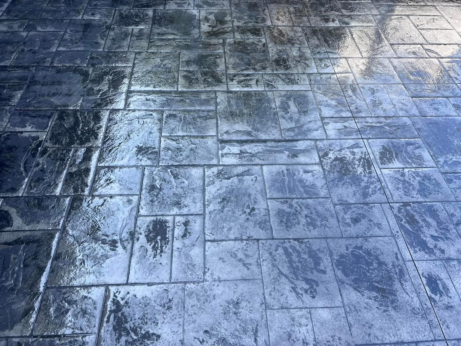 Wet stamped concrete patio surface with rectangular pattern