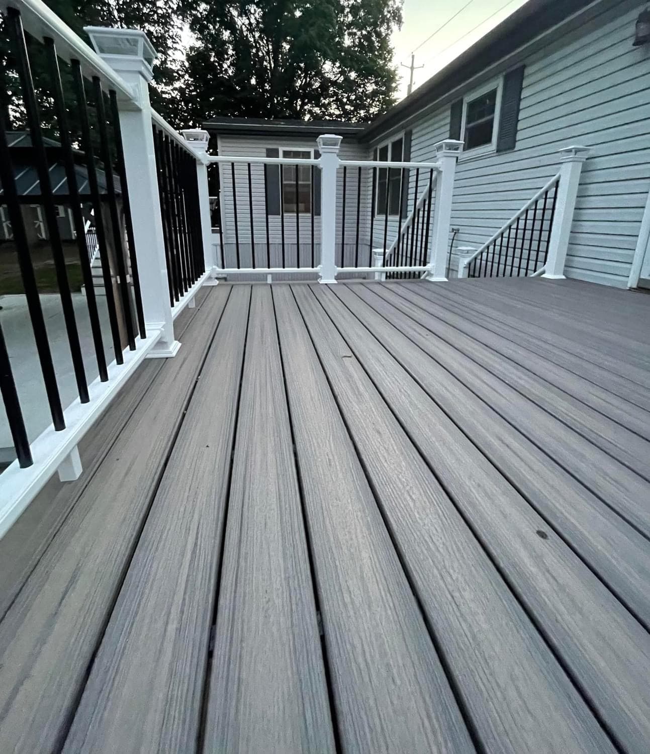 Gray composite deck with white posts and black metal balusters