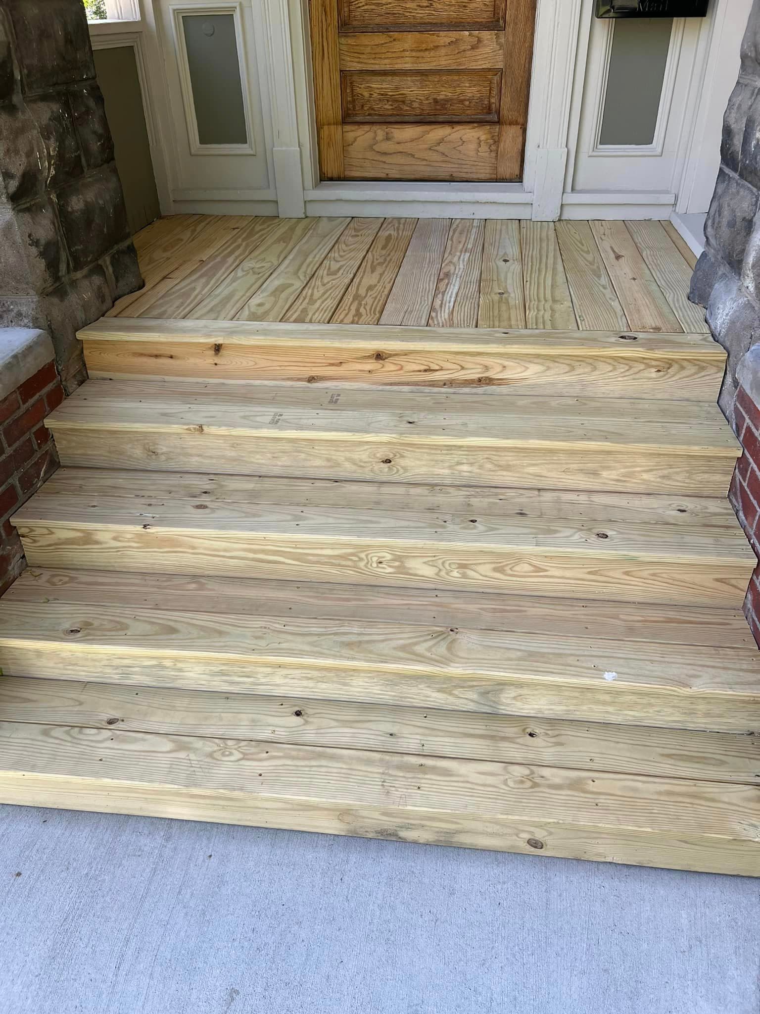 New pressure-treated wood steps and porch landing at front entrance