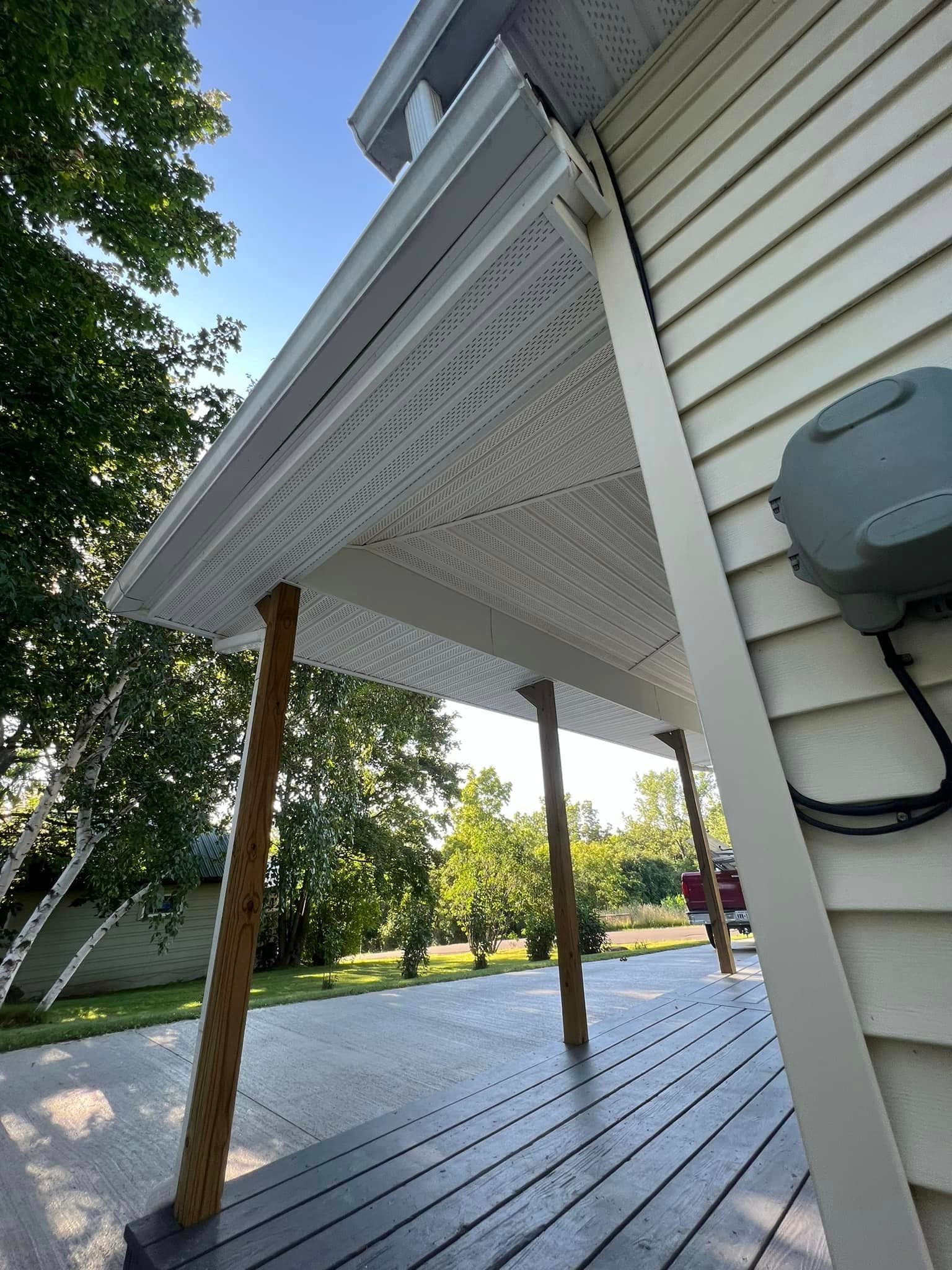 Covered porch with vented white soffit and wooden support posts
