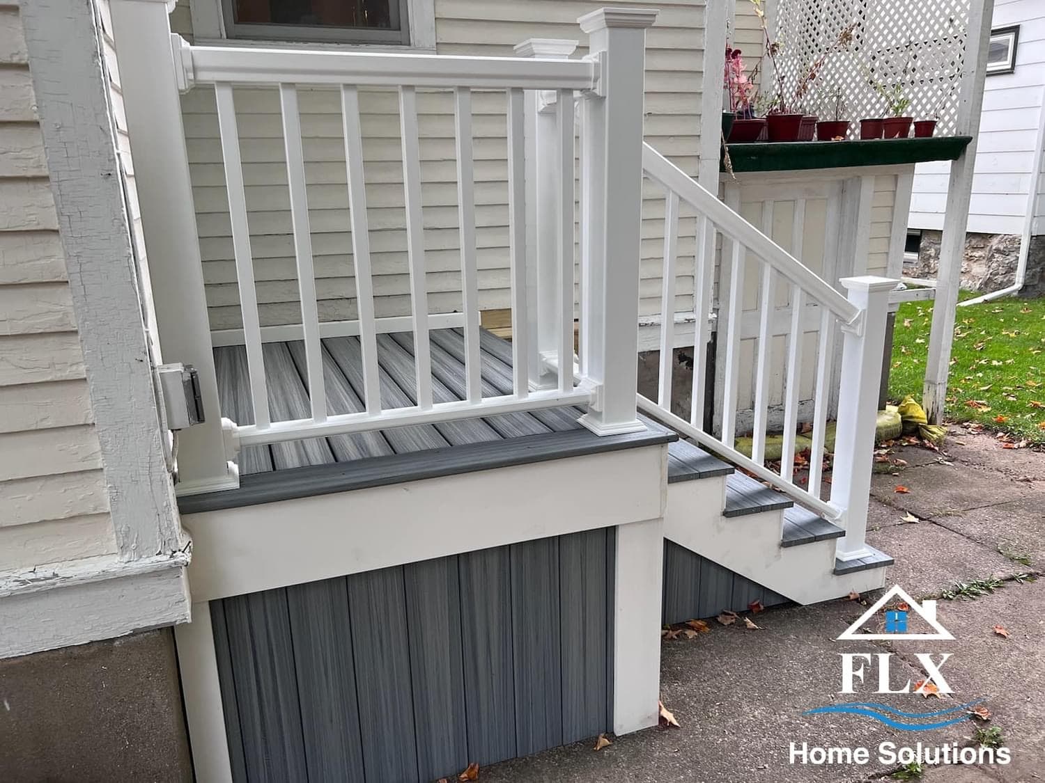 White porch steps and railings with gray composite decking