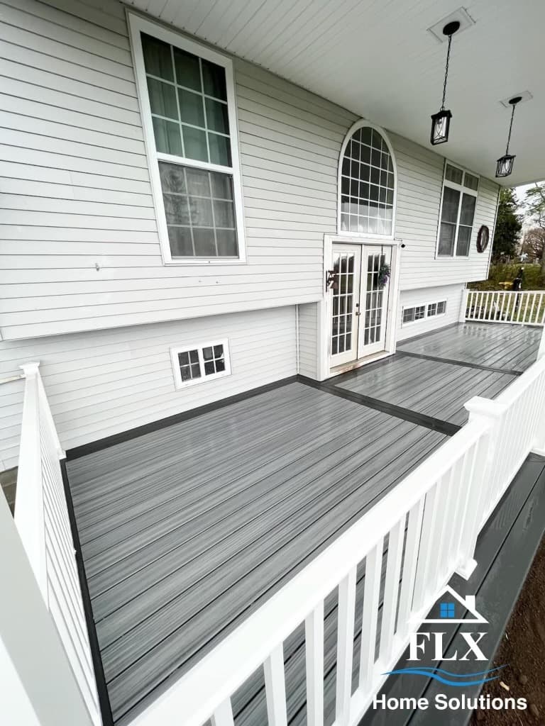 Multi-level composite deck with gray flooring and white railings