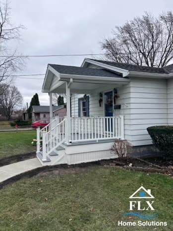 White covered front porch with railings and steps on residential home