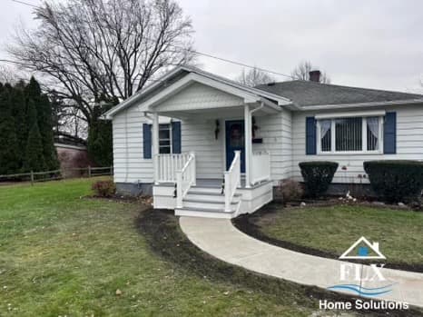 White sided ranch home with covered front porch and blue shutters