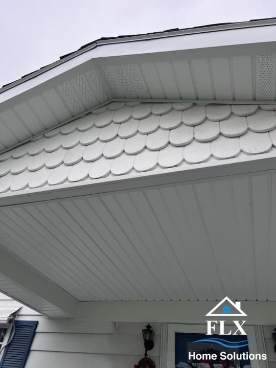 White vinyl soffit with vented panels and decorative scalloped roof shingles