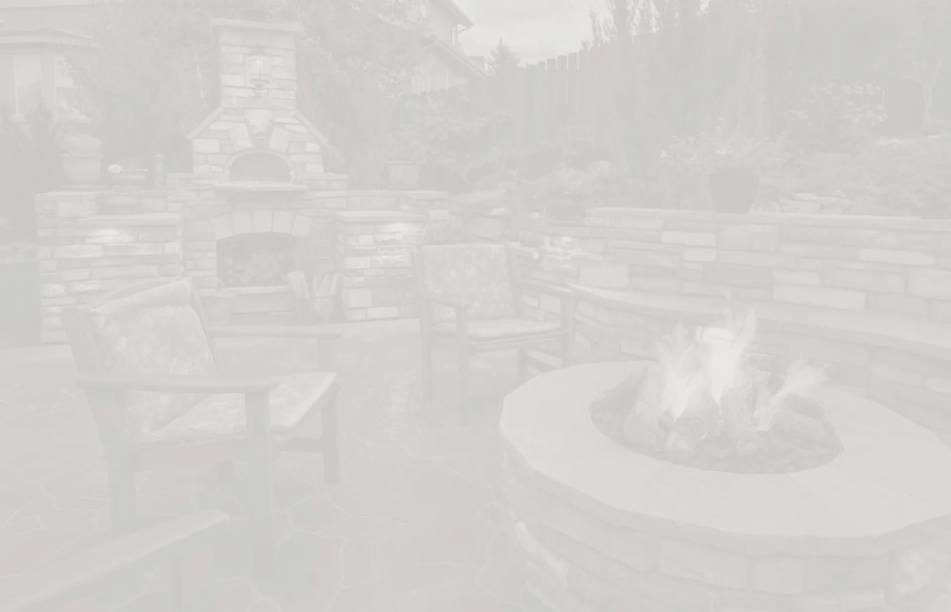 Outdoor stone fireplace and patio with seating area