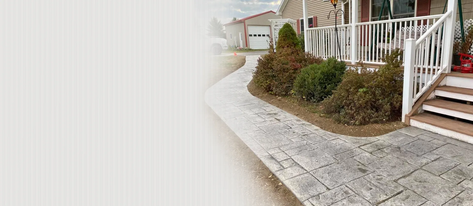 Stamped concrete walkway with decorative pattern leading to front porch
